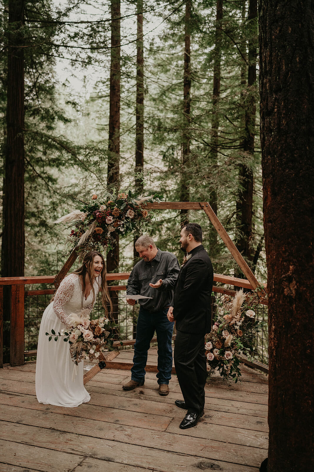 Bride and groom laugh during wedding ceremony at Hoyt Arboretum
