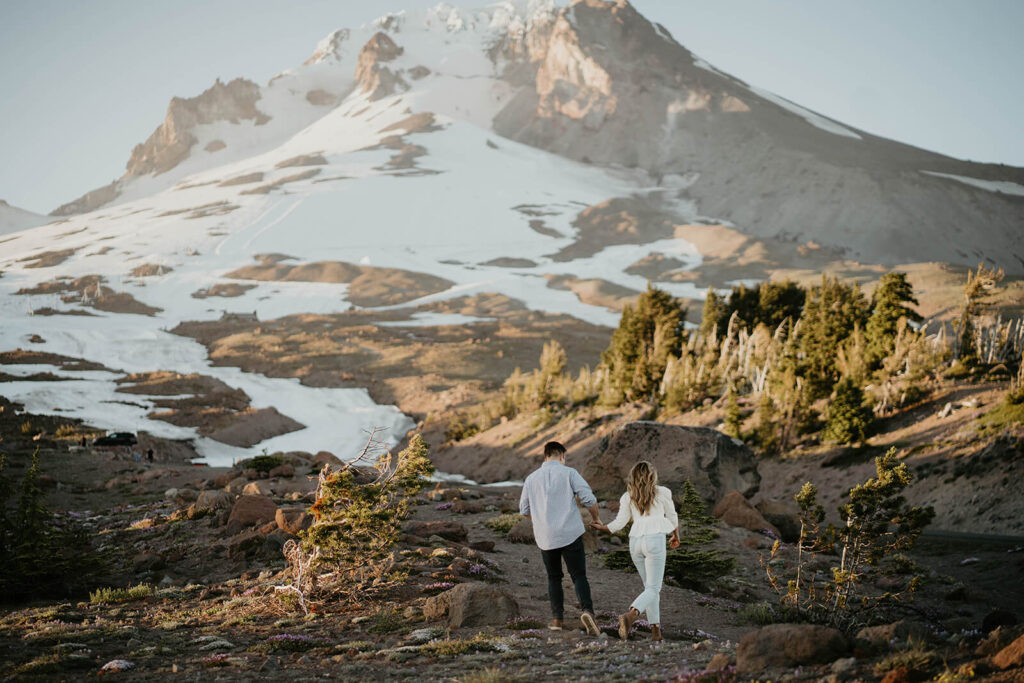Couple walking towards Mt Hood during engagement photo session