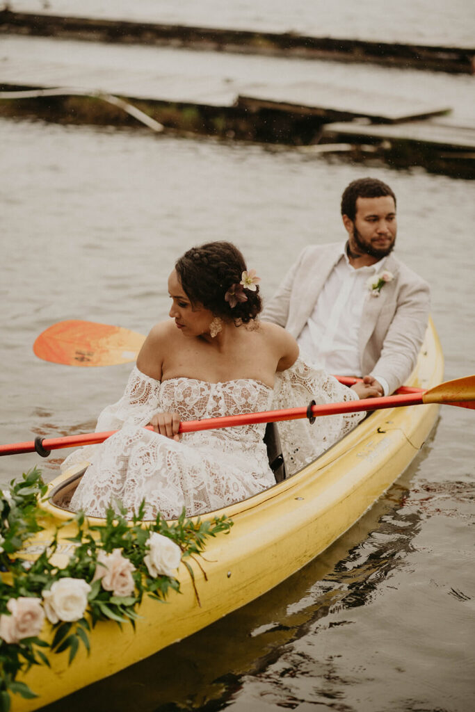 Bride and groom kayaking during their Oregon Coast elopement