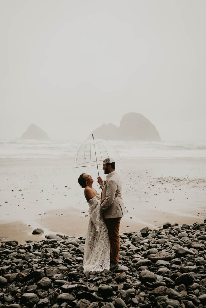 Bride and groom portraits in the rain on the Oregon coast