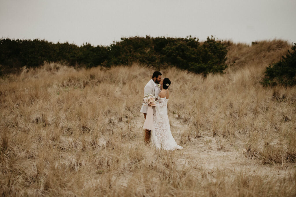 Bride and groom kissing after first look on the Oregon coast