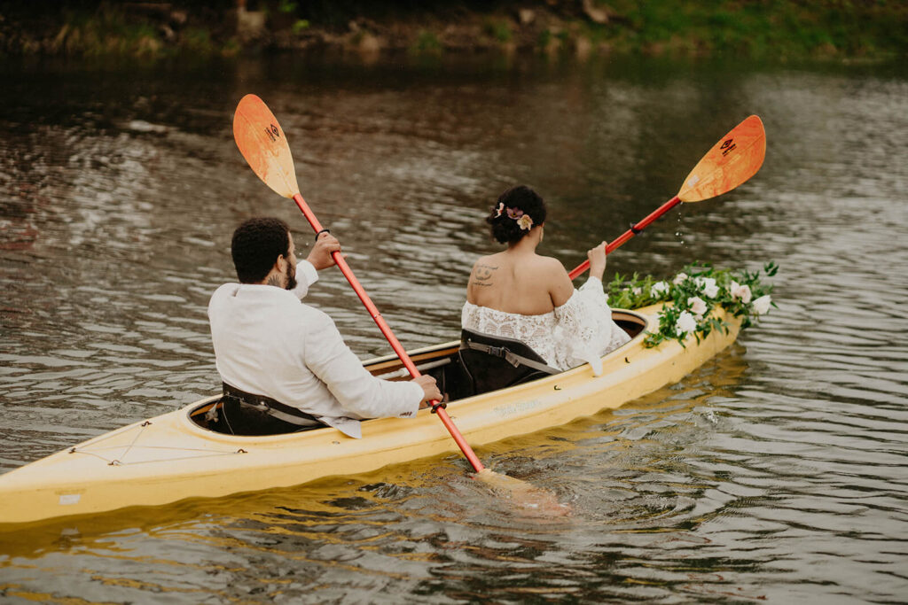 Bride and groom kayaking on the Oregon coast