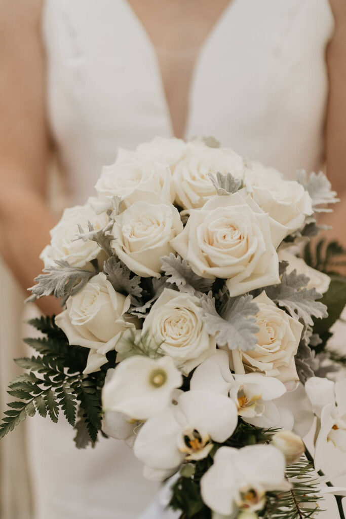 White wedding floral bouquet with roses and orchids