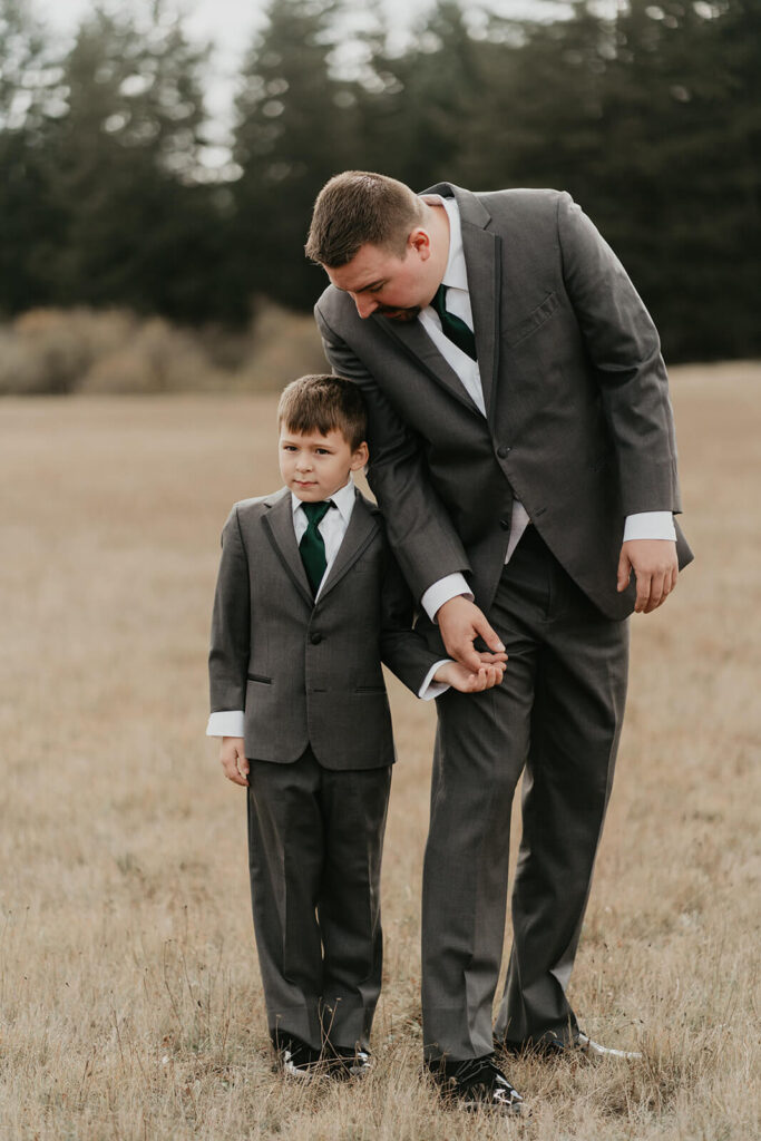 Groom holding son's hand at Silver Falls wedding