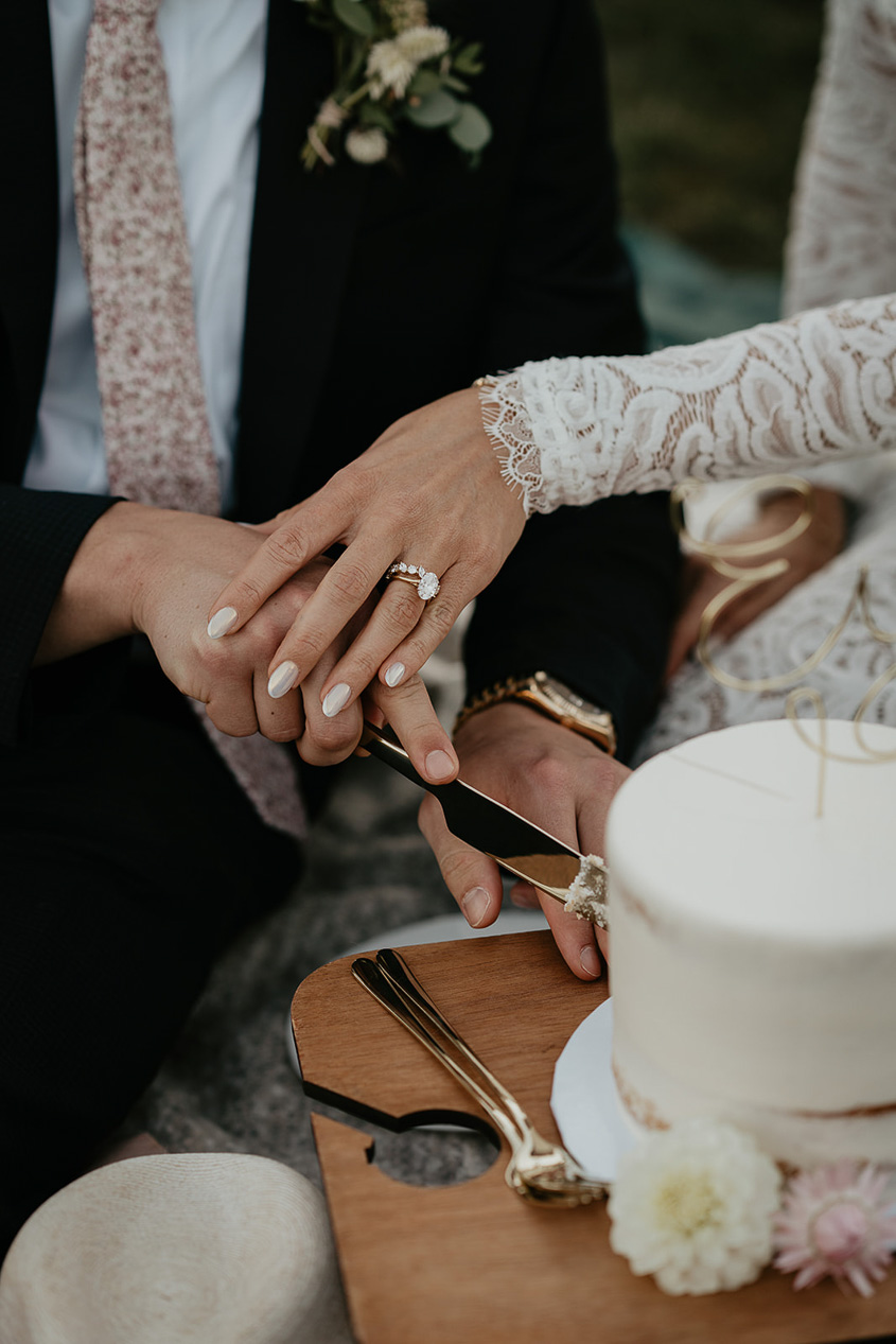 The bride and groom cutting their cake. 