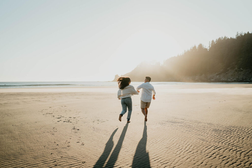 Two women running across the beach on the Oregon Coast