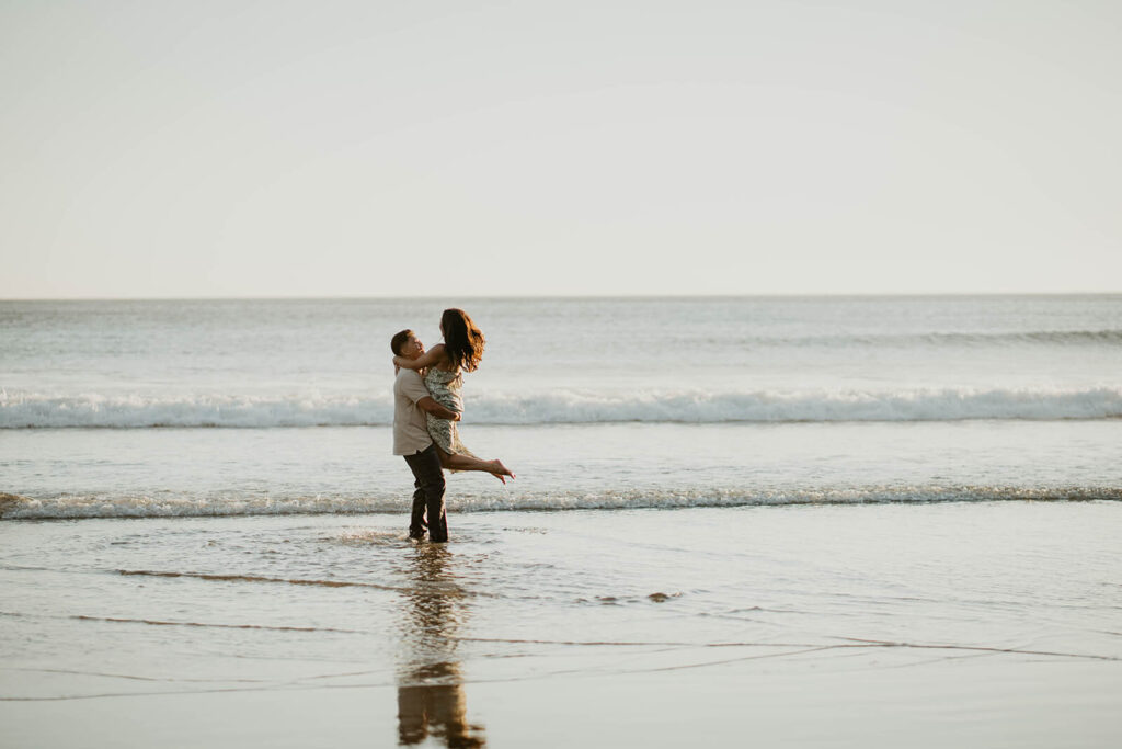 Couple dancing in the water on the Oregon Coast