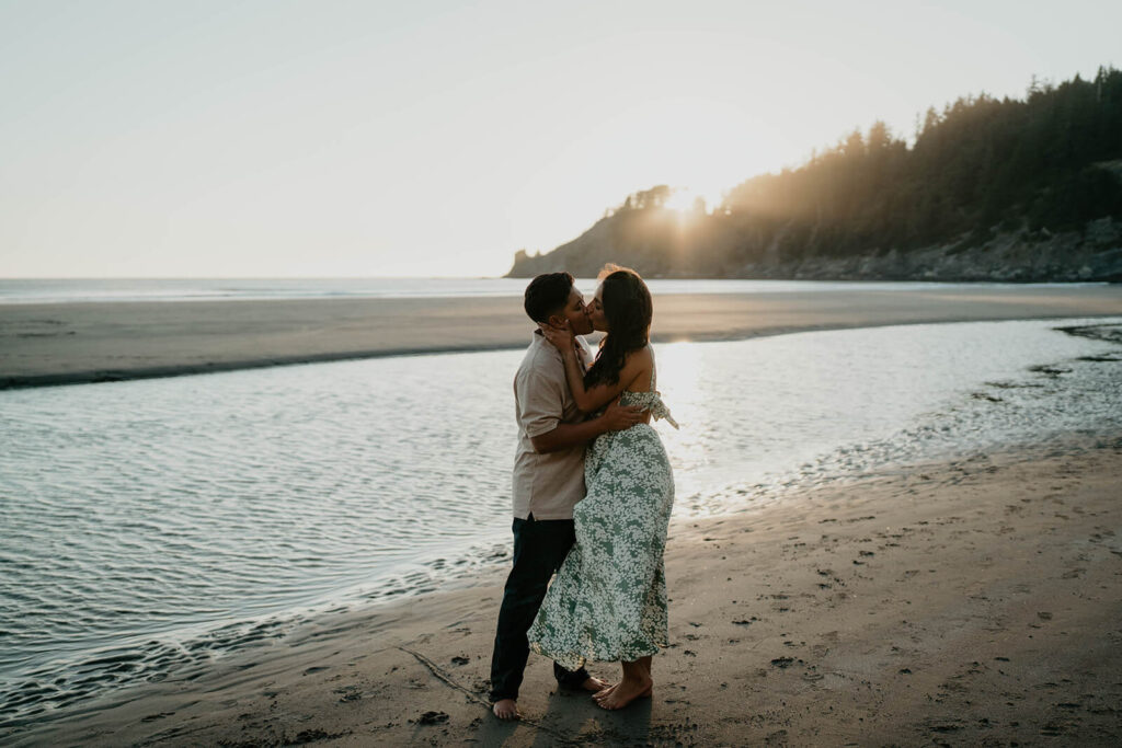 Two women kissing at sunset on the Oregon Coast