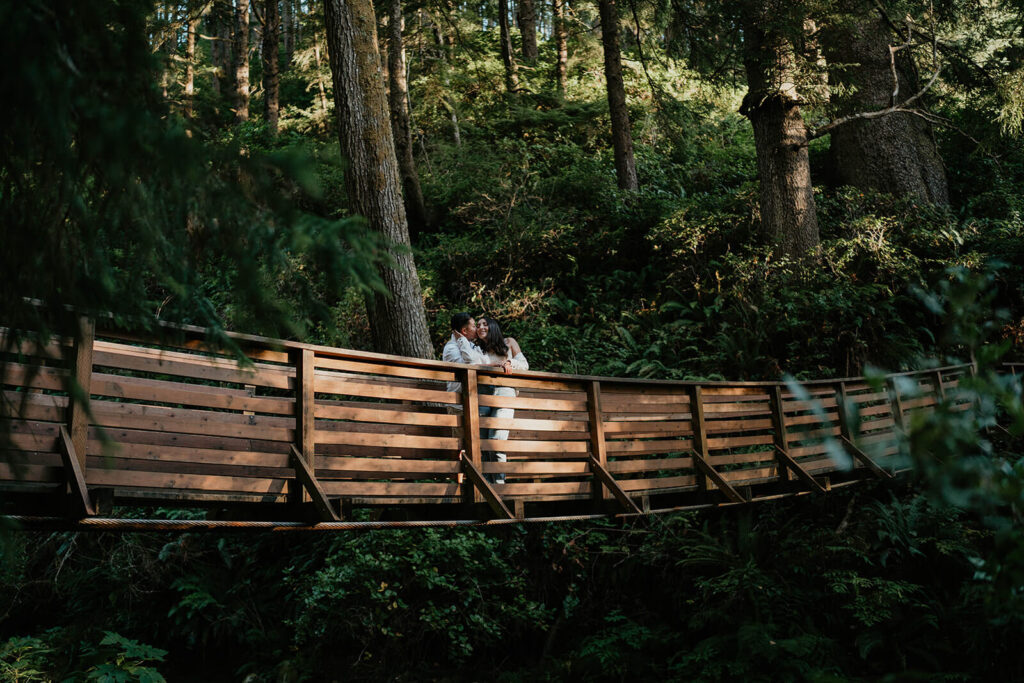 Two women standing on a bridge during Oregon engagement photos