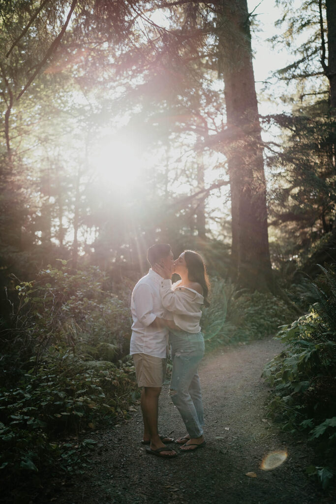Two women kissing in the forest during Oregon engagement photos