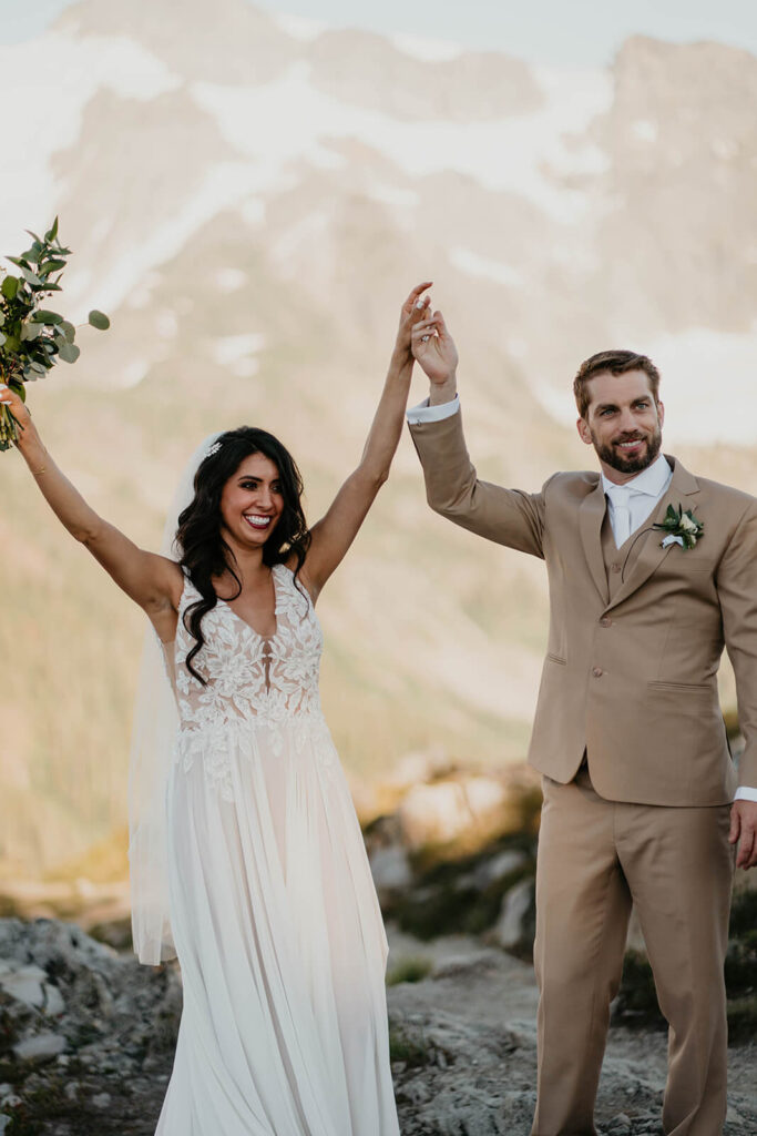 Bride and groom cheer after elopement ceremony at Artist Point