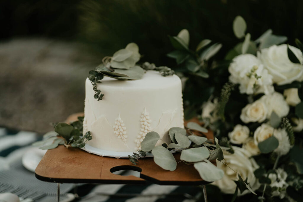White wedding cake with eucalyptus