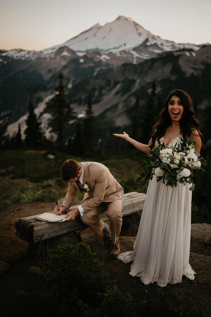 Groom signing marriage license in the North Cascades