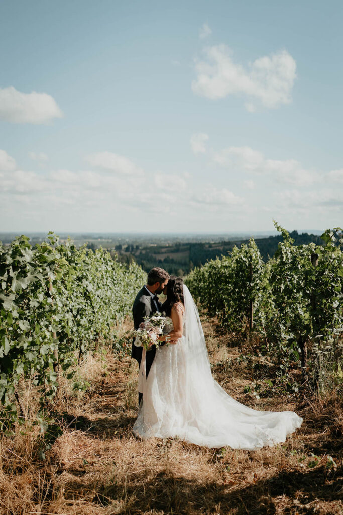 Bride and groom kiss after first look at Furioso Vineyards