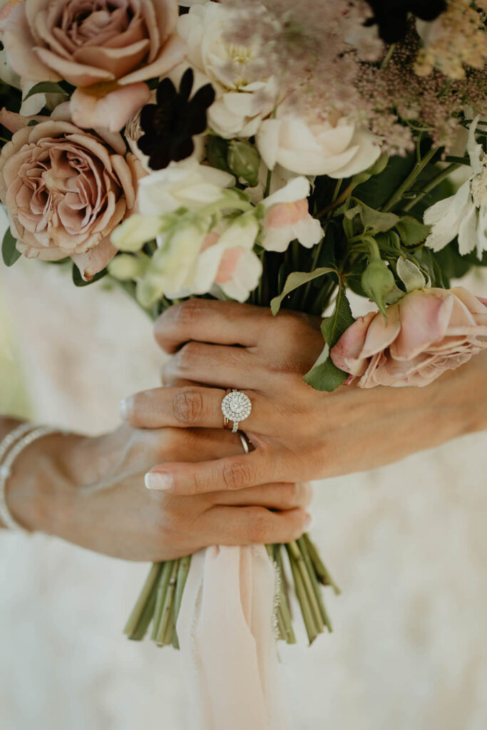 Bride holding white and pink floral bouquet