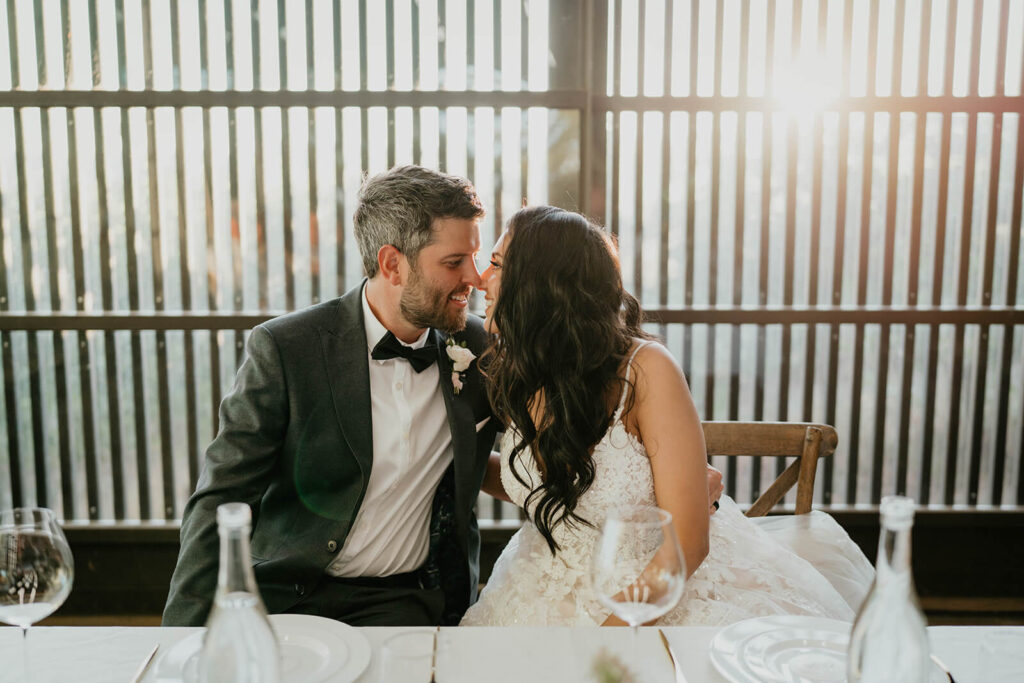 Bride and groom kissing during Oregon vineyard wedding reception