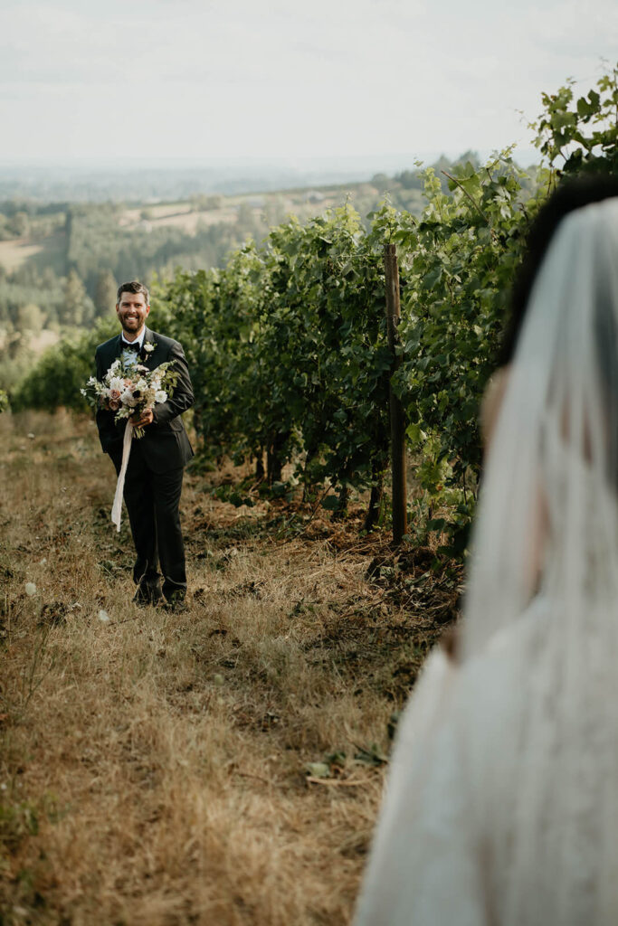 Bride and groom first look in the vineyard at Furioso Vineyards