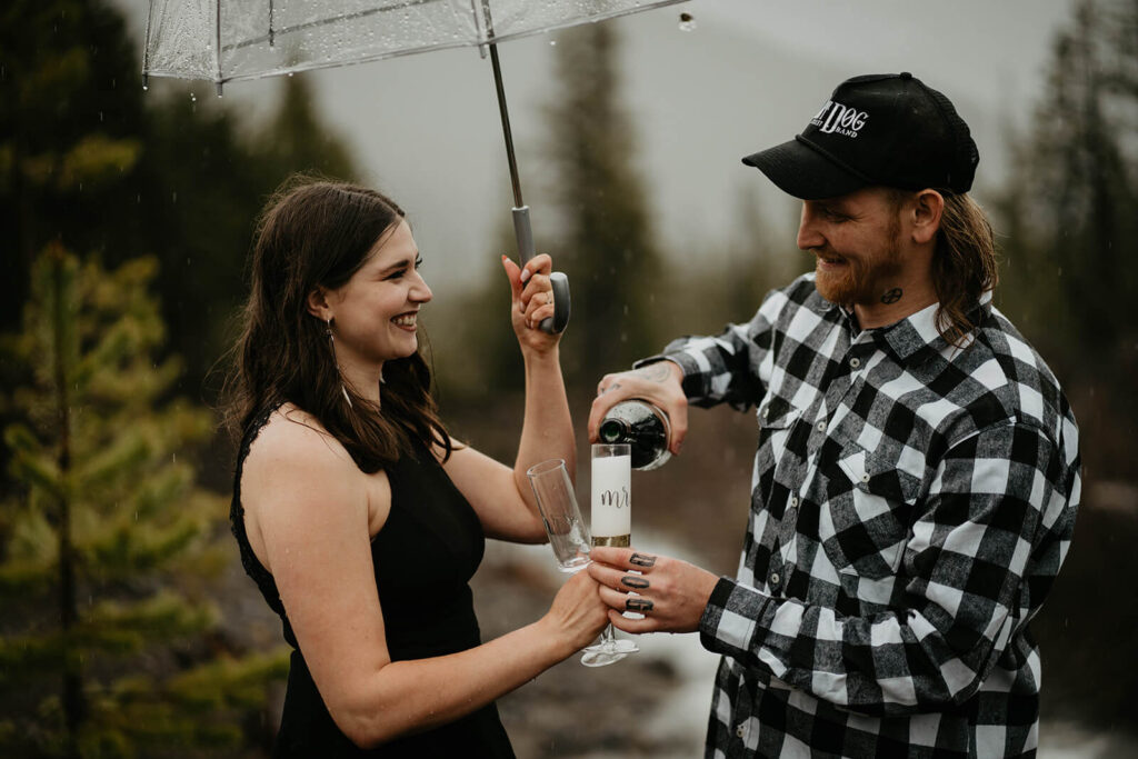 Coule pouring champagne for unique engagement photos at Mt Hood