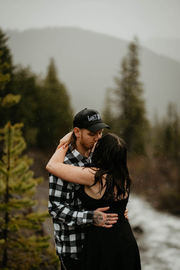 Couple kissing during unique engagement photos at Mt Hood