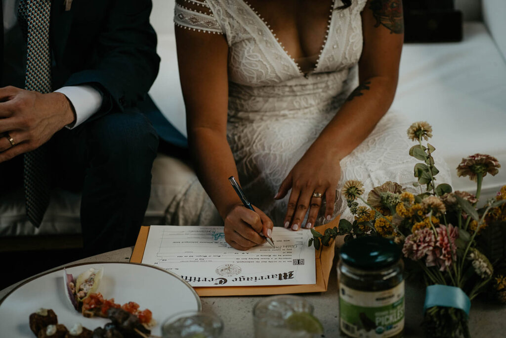 Bride and groom sign marriage license at Blockhouse wedding