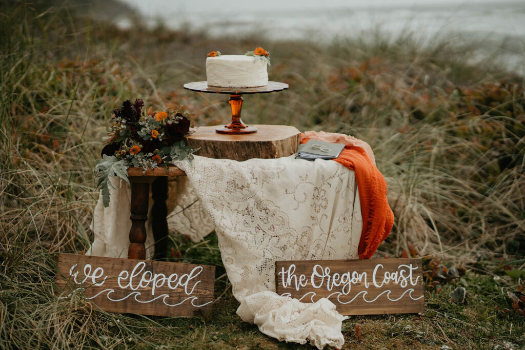 Orange and white elopement cake table setup