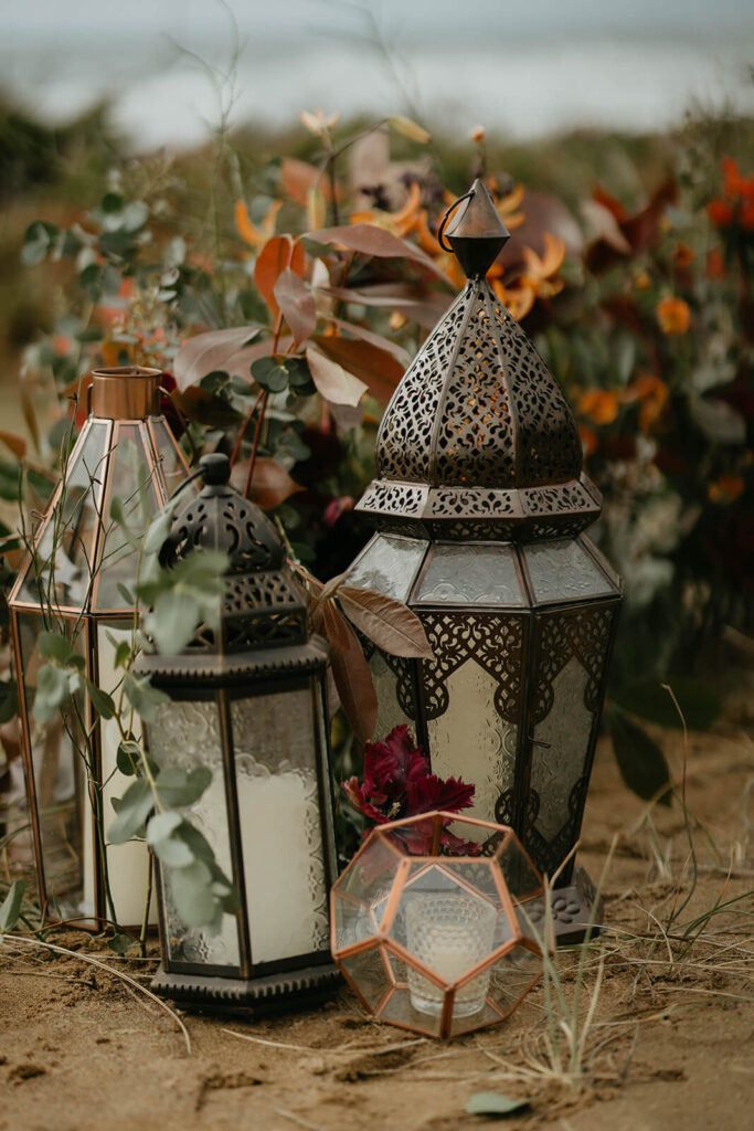 Lanterns around elopement ceremony floral arrangement