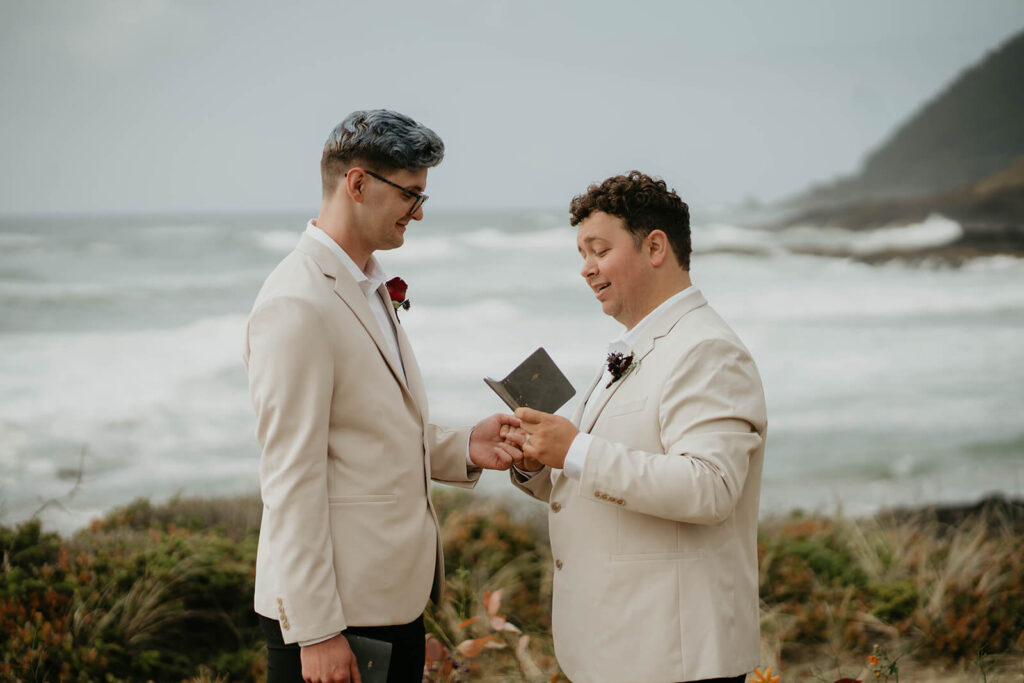 Grooms reading elopement vows at their Oregon Coast elopement ceremony