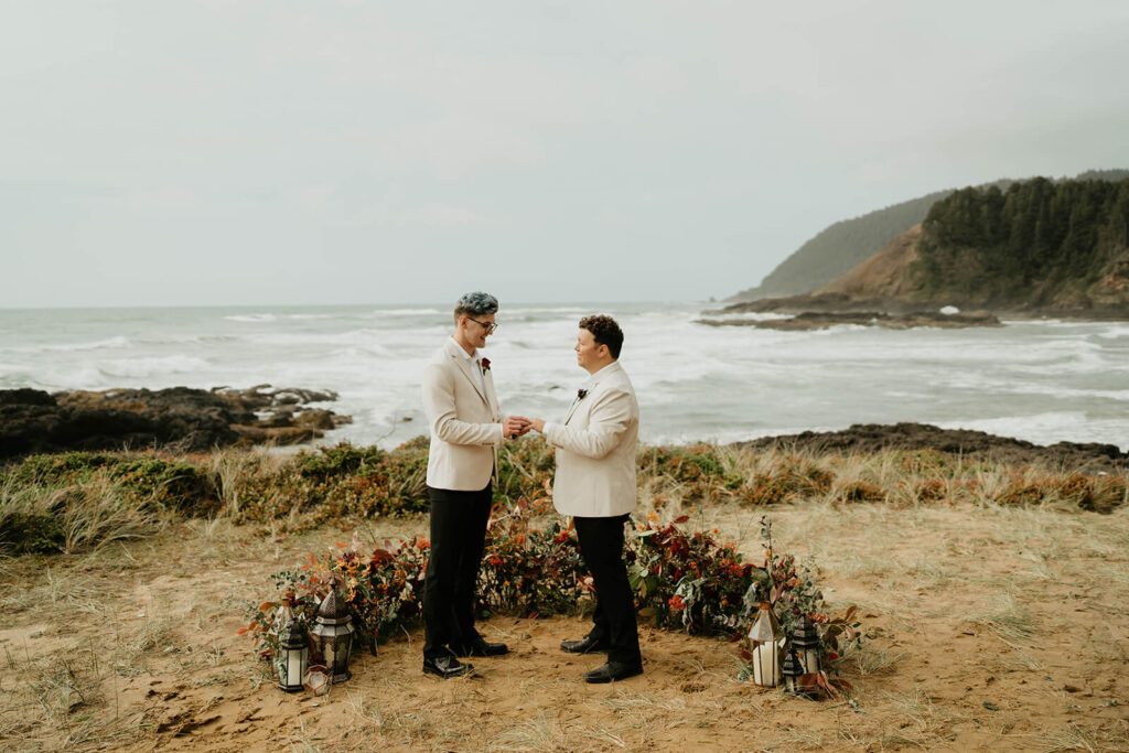 Grooms exchanging rings at their Oregon Coast elopement ceremony