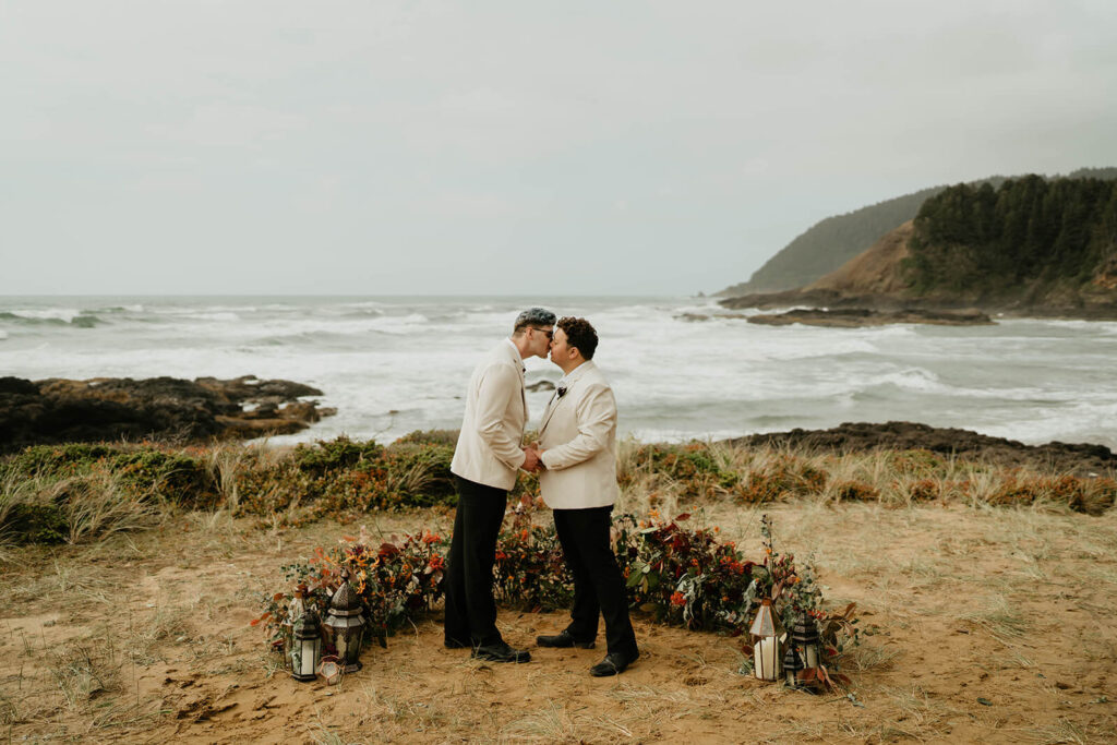 Grooms kiss during their Oregon Coast elopement ceremony