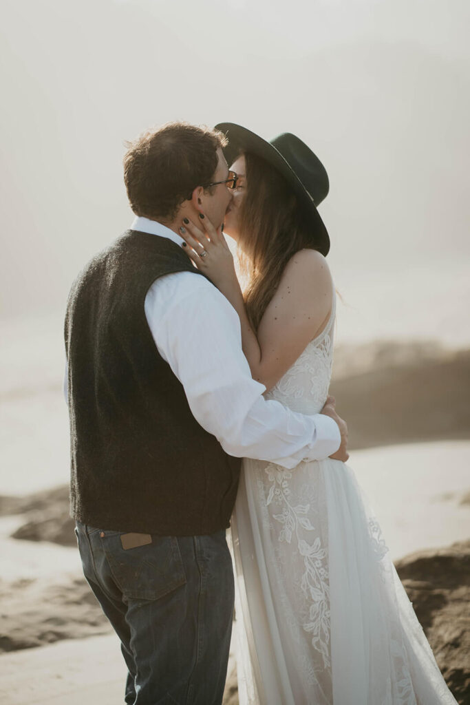 Bride and groom kiss during intimate wedding ceremony at the Oregon Coast