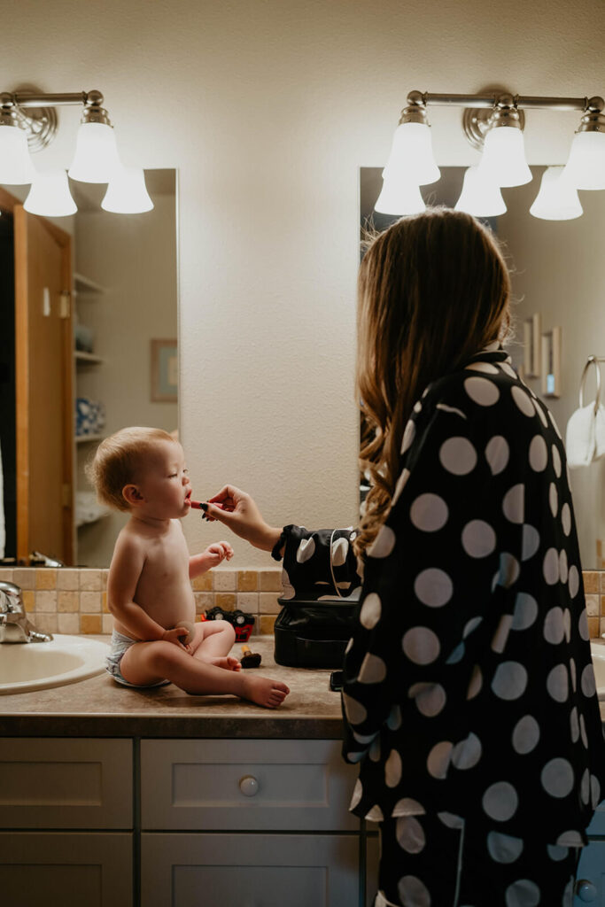 Bride getting ready with baby daughter 