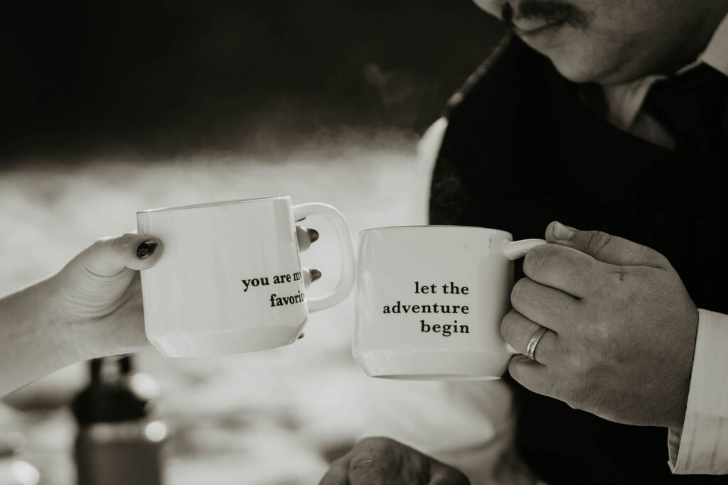 Bride and groom holding mugs that say "you are my favorite" and "let the adventure begin"