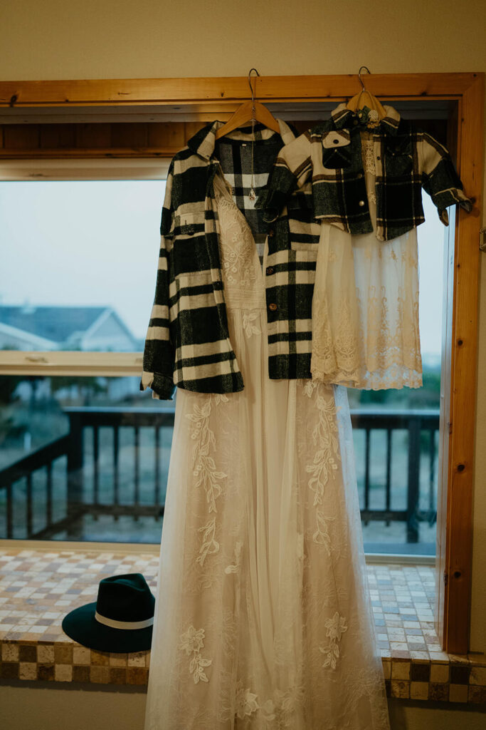 White lace wedding dress with black and white shirt jacket
