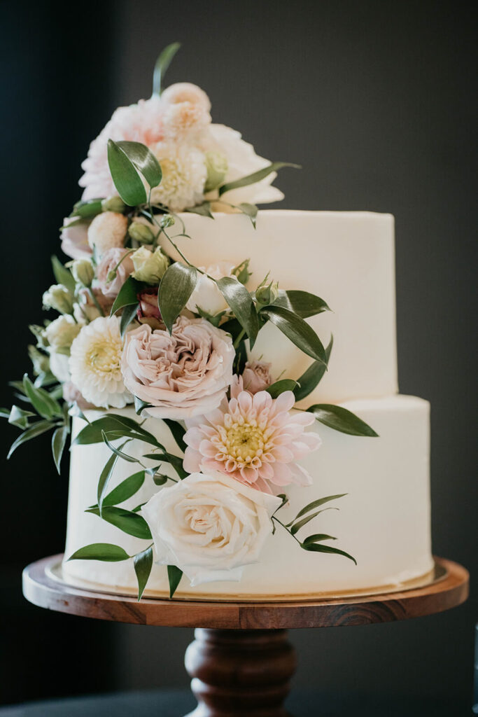 White two tier wedding cake with pastel florals