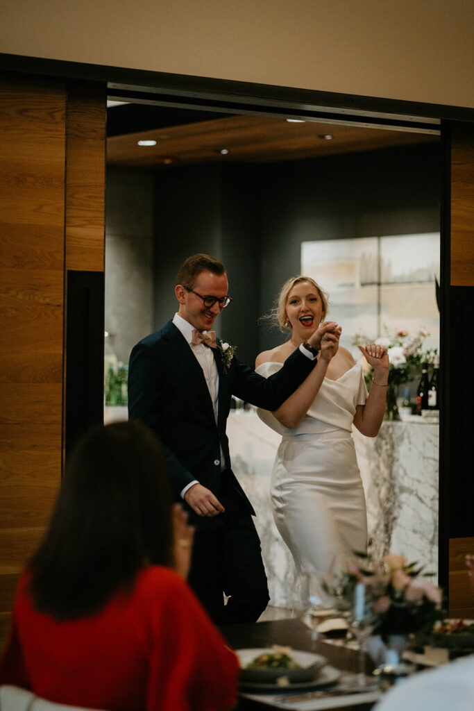 Bride and groom enter wedding reception at Ponzi Vineyards