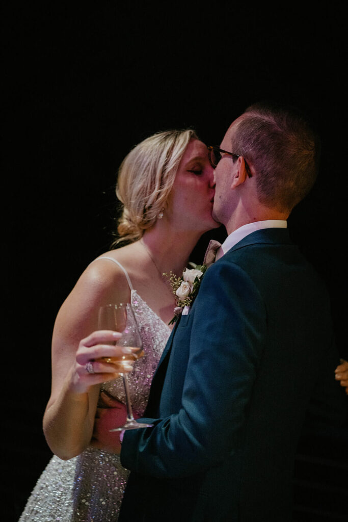 Bride and groom kiss on the dance floor at vineyard wedding in Willamette Valley