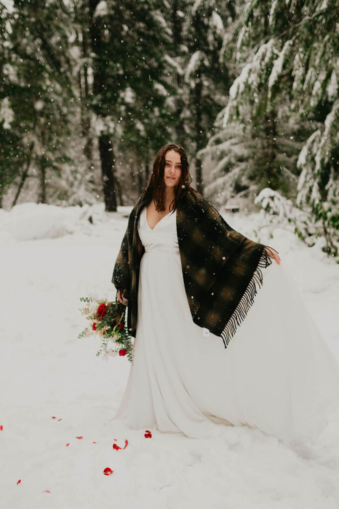Bride wearing white wedding dress with black and brown shawl