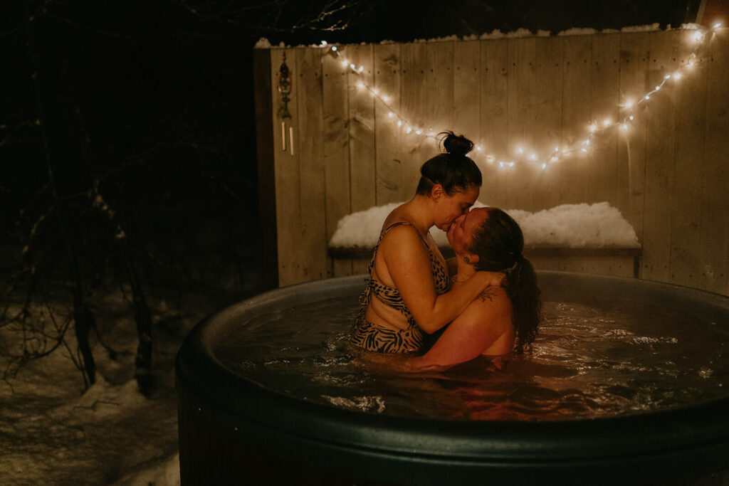 Dark moody wedding portraits in snowy hot tub
