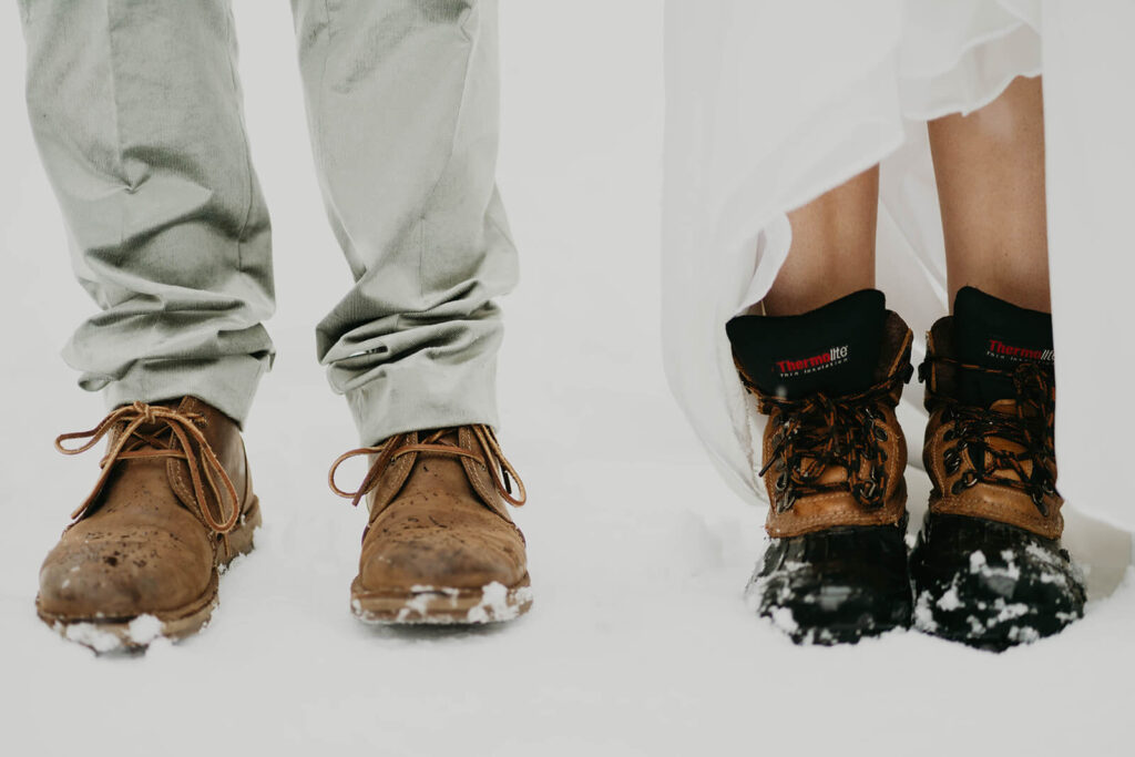 Brides wearing hiking boots in the snow