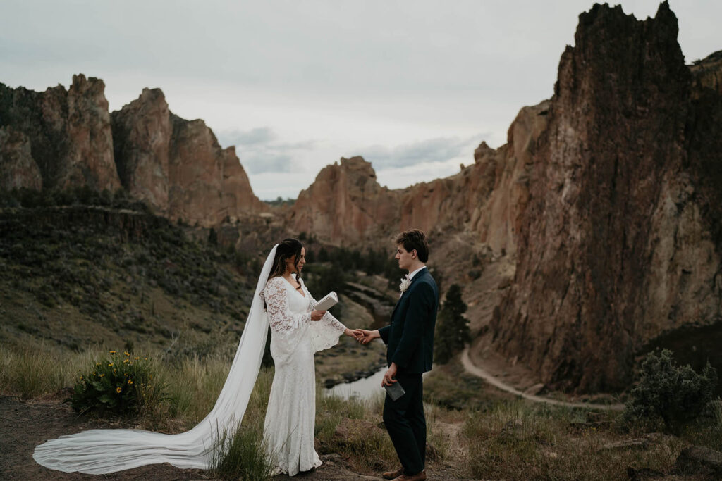 Bride and groom exchanging vows at rocking climbing elopement at Smith Rock State Park