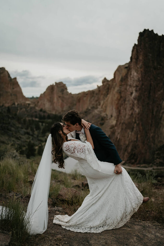 Bride and groom kissing at rock climbing elopement at Smith Rock