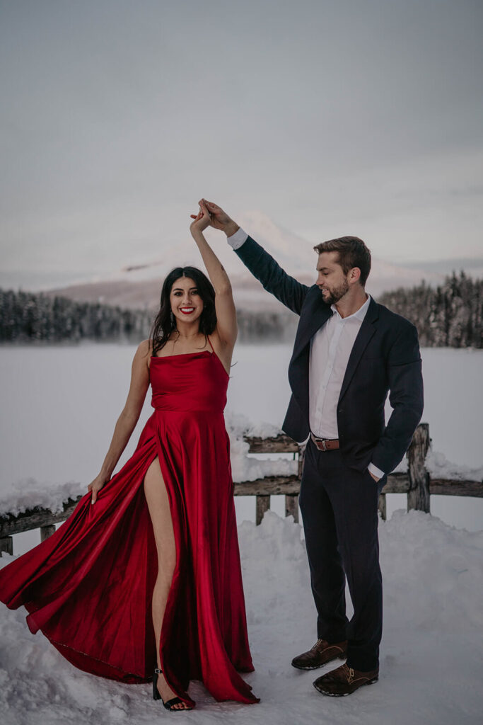 Couple dancing in the snow during Trillium Lake, Oregon engagement photo session