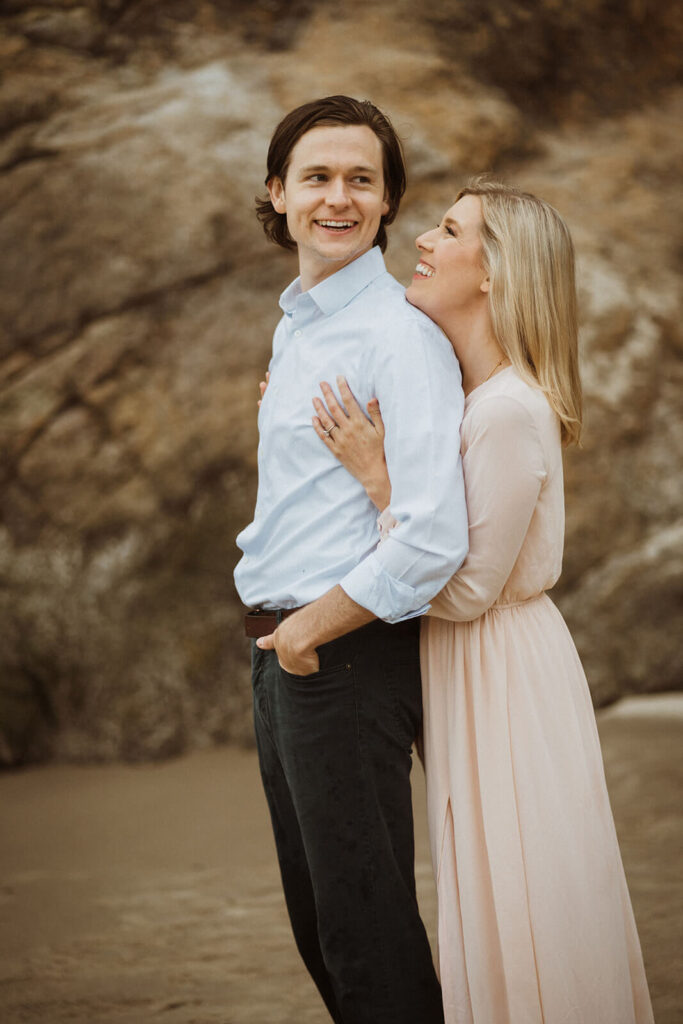 Couple hugging during engagement session at Hug Point