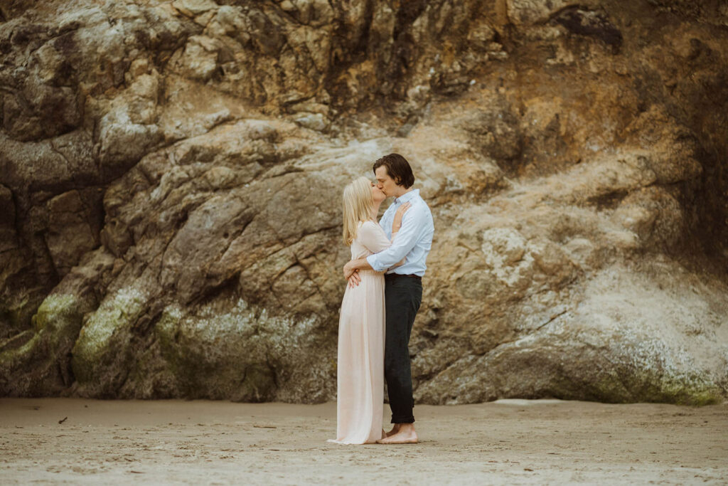 Couple kissing during engagement session at Hug Point