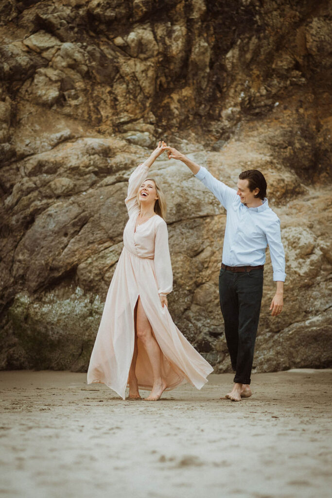 Couple dancing during engagement session at Hug Point