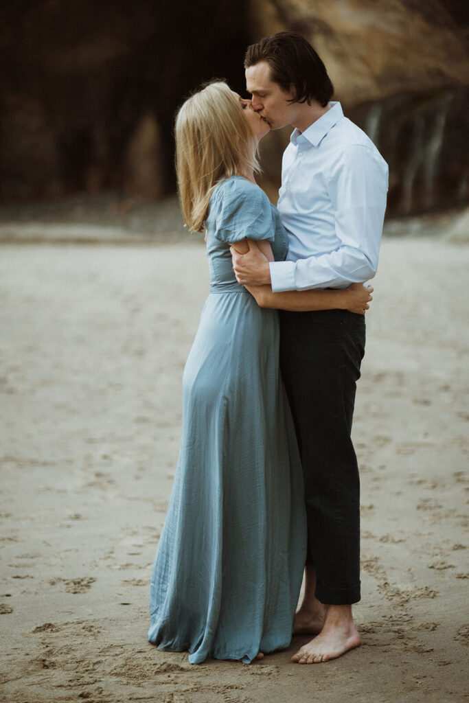 Couple kissing on the beach at Hug Point during engagement session