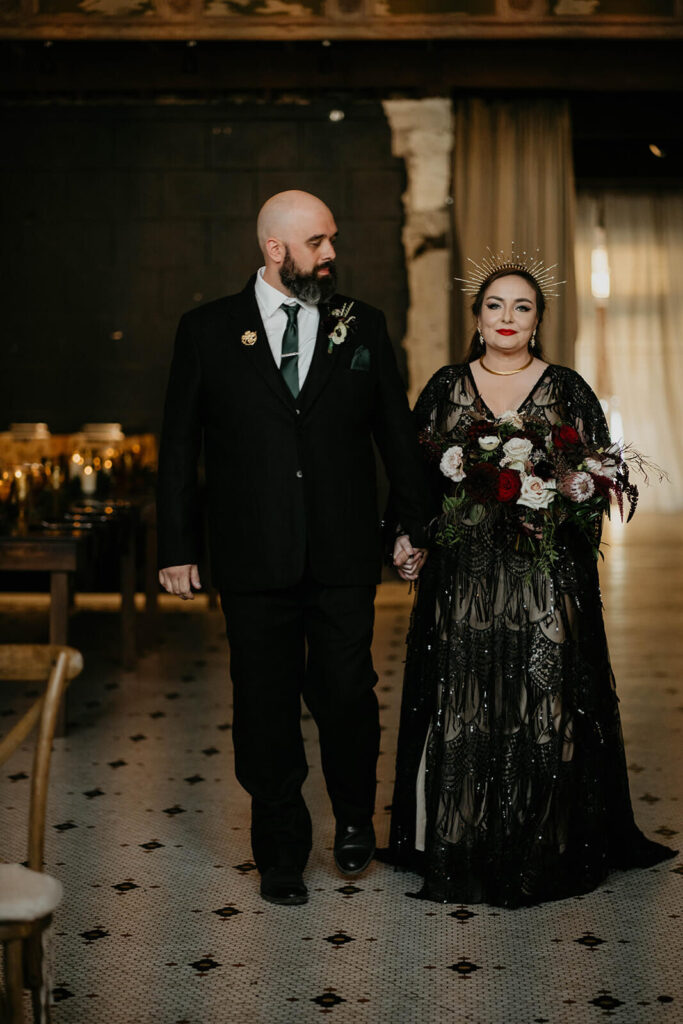 Bride and groom enter dark, moody wedding at The Ruins at the Astor