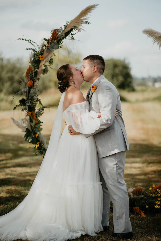 Bride and groom first kiss at romantic wedding in Washington