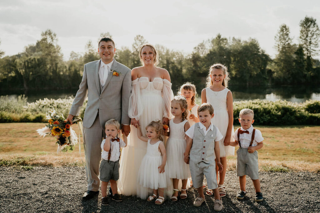 Bride and groom portrait with flower girls and boys