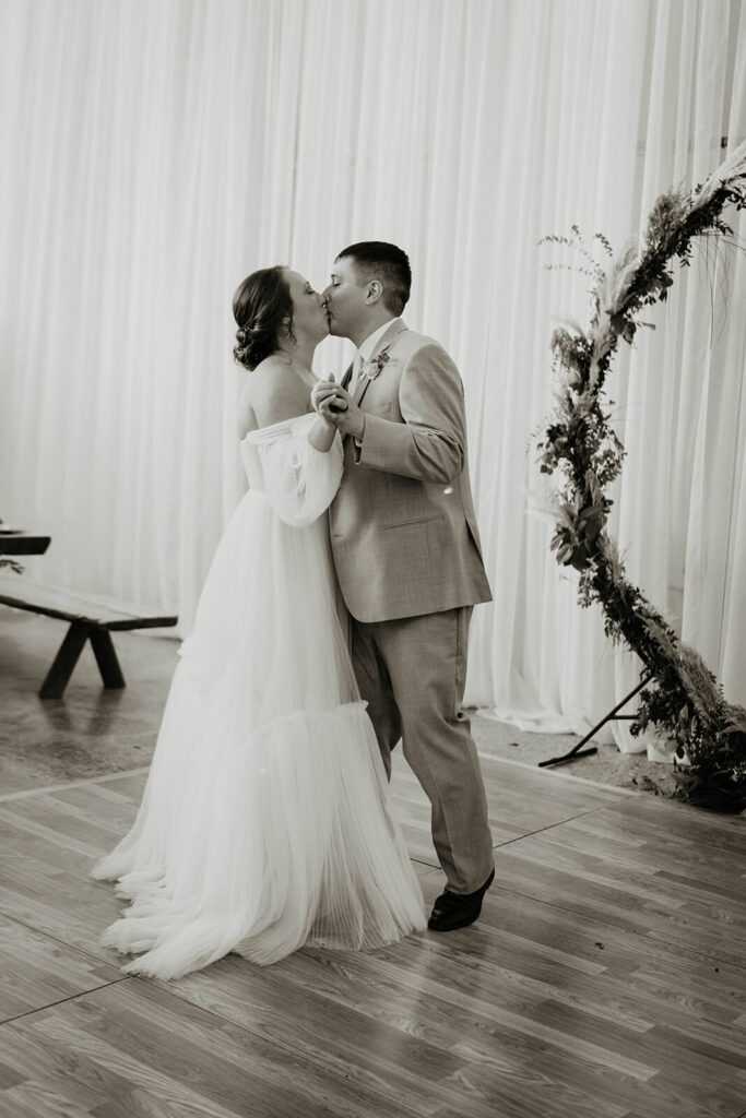 Bride and groom kiss during first dance at Pemberton Farm wedding reception